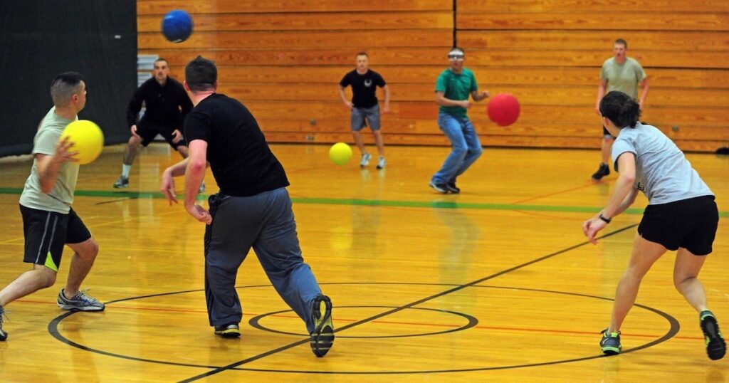 Hockey players proudly display their gold medals, celebrating their victory in the Dirty Dodgeball Team Names tournament.