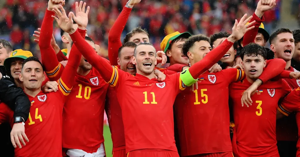 Wales players joyfully celebrate their victory after the match, embodying the spirit of "More Funny Soccer Team Names.